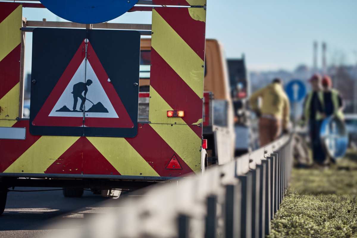 lavori in corso in autostrada, cartello e lavoratori